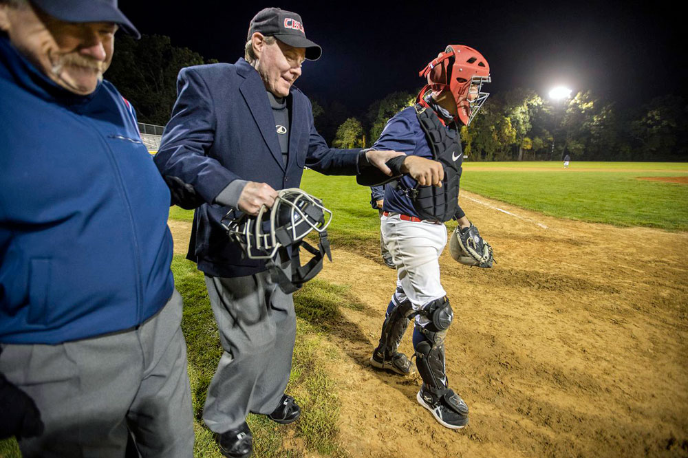 Chief umpire Walter Bentson got a little assist on his way to the plate.