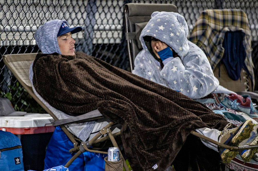 Scot Leslie, one of two players to play all 100 innings in the field, tried to stay warm in the overnight hours.